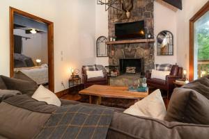a living room with a couch and a fireplace at A Smoky Mountains Retreat - Chalet de Montagne in Gatlinburg