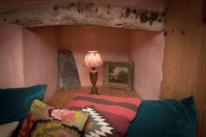 a living room with a couch and a lamp at Barns Tower in Peebles