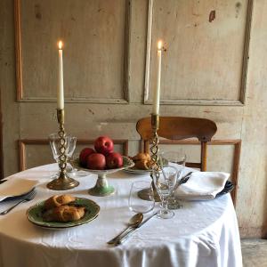 a table with two candles and a plate of food at Queen Mary's Chamber in Peebles