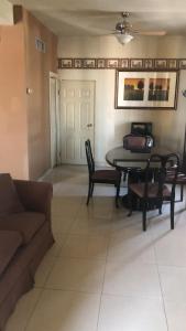 a living room with a table and chairs and a couch at HOTEL PLAZA RIVIERA in Matamoros
