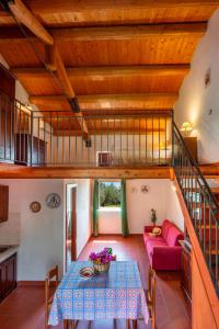 a living room with a table and a red couch at Agriturismo Borgo degli ulivi in Canicattini Bagni