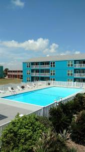 a large swimming pool in front of a building at Executive Keys Condominiums on the Beach in Port Aransas