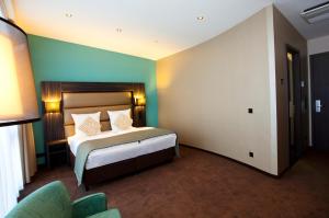 Ein Bett oder Betten in einem Zimmer der Unterkunft Centro Hotel Ayun DELUXE