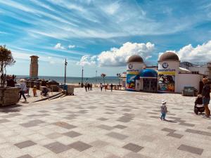 a child standing in a plaza near the beach at The Boho - 4 min walk to beach & town in Bournemouth