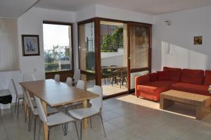 a living room with a red couch and a table at Wonderful family villa with sea view in Byala