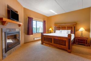 a bedroom with a bed and a fireplace at Chula Vista Resort, Trademark Collection by Wyndham in Wisconsin Dells
