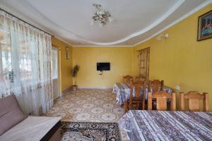 a room with two beds and a table and chairs at Захід сонця in Slavske