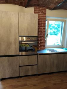 uma cozinha com utensílios de aço inoxidável e uma janela em LA LEGIUN STRANIERA em Boves