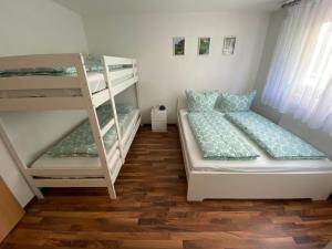 a bedroom with two bunk beds and a ladder at Ferienwohnung Müller in Lahr