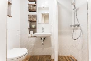 a white bathroom with a sink and a toilet at Apartmán u Stromovky nedaleko centra in Prague