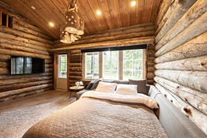 1 dormitorio con 1 cama en una cabaña de madera en UnelmaRepo, en Ruka