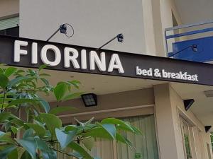 a sign that reads floreina bed and breakfast on a building at Fiorina Bed&Breakfast - Colazione fino a mezzogiorno - Beach Village gratuito in Riccione
