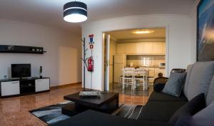 a living room with a couch and a table at Casa da Rocha - Alojamento Local in Vila Nova de Foz Coa