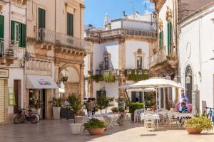 a courtyard with tables and umbrellas in a building at Le Marangi Getaway Suite in Martina Franca