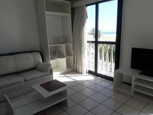 sala de estar con sofá y vistas al océano en Classic Residence Beira Mar, en Fortaleza