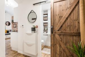 a bathroom with a sliding barn door and a toilet at Apartmán u Stromovky nedaleko centra in Prague