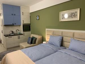 a bedroom with two beds and a kitchen in it at Sea&Center Lux in Bar