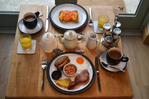 a table with two plates of breakfast food and coffee at Dalecote Barn Bed & Breakfast in Ingleton