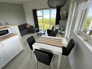 a kitchen and living room with a table and chairs at Skeiðvellir Panorama house in Hella