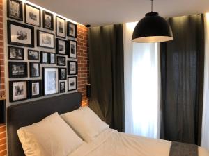 a bedroom with a bed and a wall of pictures at Appartement Hainaut Paris XIXème in Paris