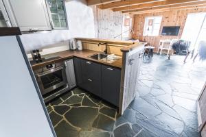 a kitchen with a sink and a stove at The View in Bøur