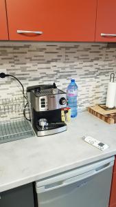 a kitchen counter with a toaster on a counter top at Lux apartment in Montana