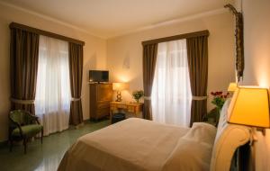 מיטה או מיטות בחדר ב-Albergo Russo