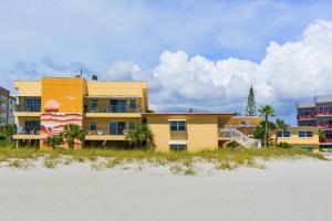 a building on the beach next to the beach at 239 Surf Song Resort in St. Pete Beach