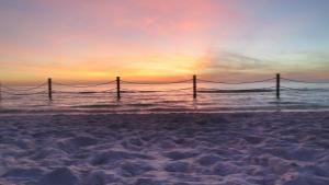 a volleyball net on the beach at sunset at 239 Surf Song Resort in St. Pete Beach