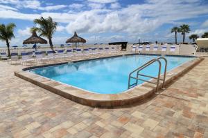 a swimming pool with a stairway leading to a resort at 310 Beach Place Condos in St Pete Beach