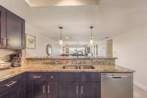 a kitchen with a sink and a counter at 102 Beach Place Condos in St. Pete Beach