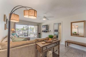 a living room with a couch and a table at 102 Beach Place Condos in St. Pete Beach