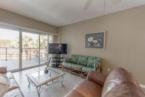 a living room with a couch and a table at 104 Crimson Condos in St. Pete Beach