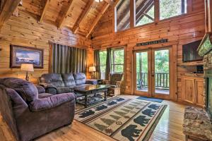 a living room with a couch and a table in a cabin at Sky Harbor Sevierville Cabin with Hot Tub and Deck! in Pigeon Forge