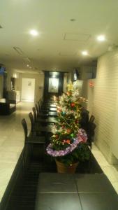 a christmas tree in the middle of a row of chairs at Hamilton Hotel Black in Nagoya +27 photos