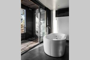 a bath tub in a bathroom with a window at Deviot Boat House in Deviot