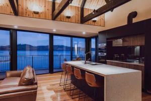 a kitchen with a counter with a couch and some windows at Deviot Boat House in Deviot