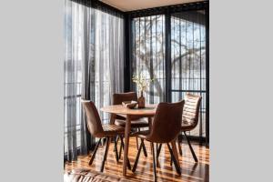 a dining room with a wooden table and chairs at Deviot Boat House in Deviot