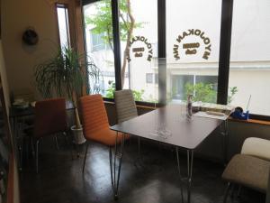 a dining room with a table and chairs and windows at Hakone Miyanoshita Myojokan in Hakone +40 photos