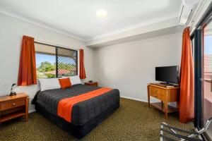 a hotel room with two beds and a television at Quality Inn Grafton in Grafton