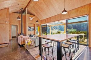 a kitchen and living room with a large table and chairs at The Waikato Lookout - Whakamaru Holiday Home in Mangakino