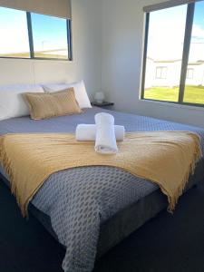 a hotel room with a bed and a window at Swansea Holiday Park Tasmania in Swansea