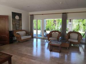a living room with chairs and a coffee table at La Luna Blanca in Torremolinos