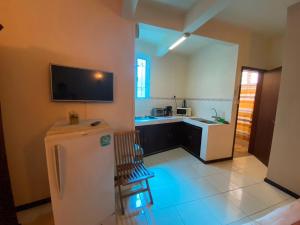 a kitchen with a white refrigerator in a room at Monalysa Holidays in Grand-Baie