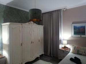 a living room with a white cabinet and a lamp at Casa Marina in Caldas de Reis