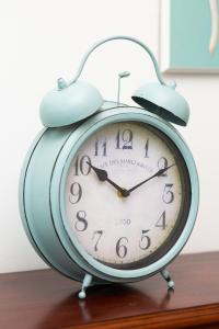 a blue alarm clock sitting on top of a table at Apartments Warsaw Browarna by Renters in Warsaw