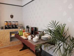 a kitchen with a table with dishes on it at Adams Guest House in Oxford