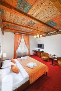 a bedroom with a large bed and a living room at Hotel Lippert in Prague