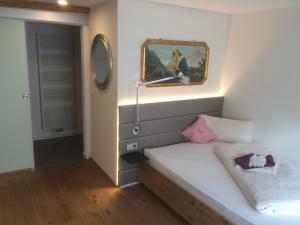 ein Schlafzimmer mit einem Bett mit einer Lampe in der Unterkunft Zum Hirschen - hotel & gasthaus beim stöckeler in Scheidegg