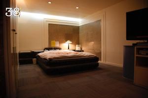 a bedroom with a bed and a flat screen tv at HOTEL K's GOMANGOKU adult only 